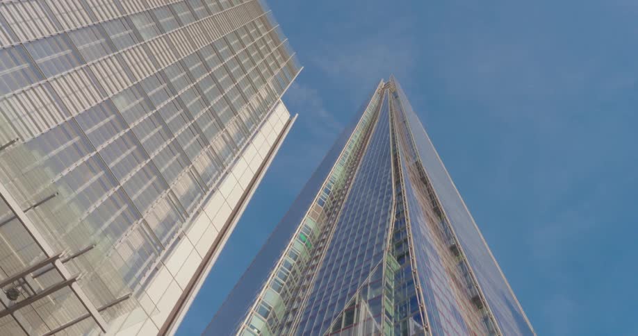 A low angle view of the shard skyscraper in london against a blue sky