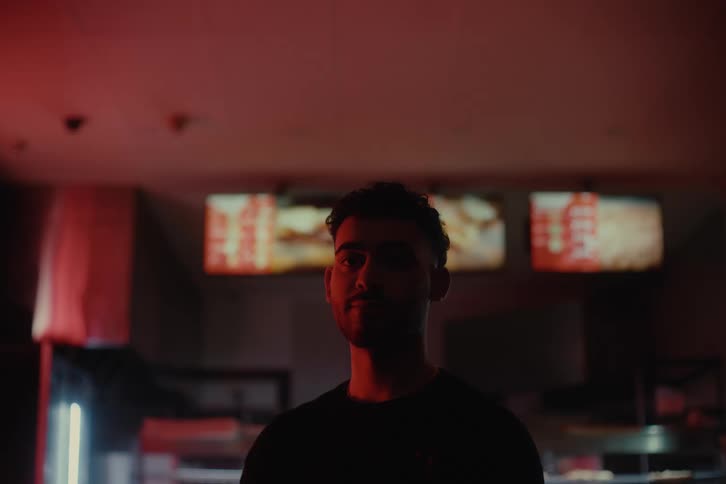 Portrait of a man inside a restaurant with low lighting
