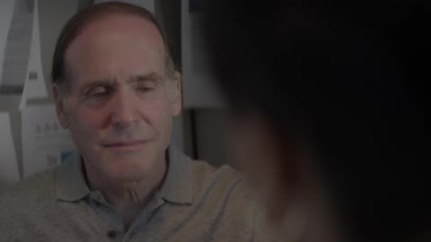 Man listening and nodding while another person is talking
