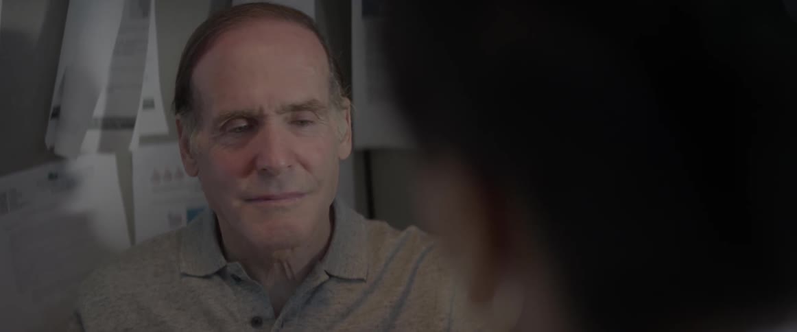 Man listening and nodding while another person is talking