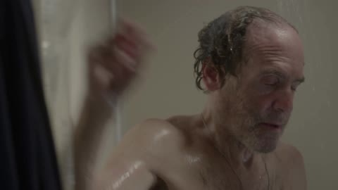 Man washing his hair in shower