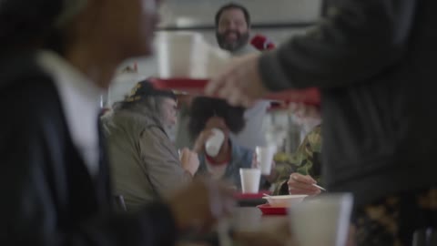 People sitting and eating food in a cafeteria