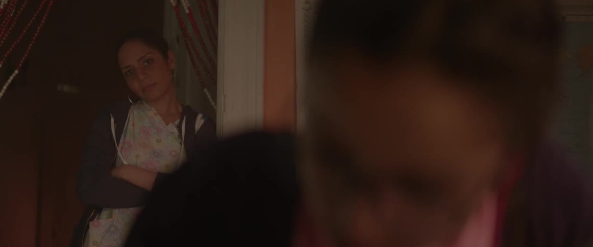 A mother watching her daughter study from behind