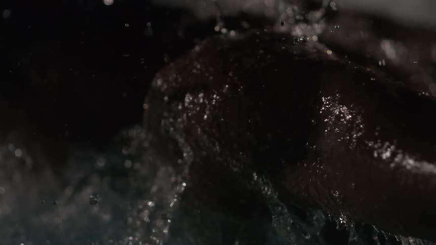 A man is coming out from under the water of a swimming pool doing a butterfly stroke