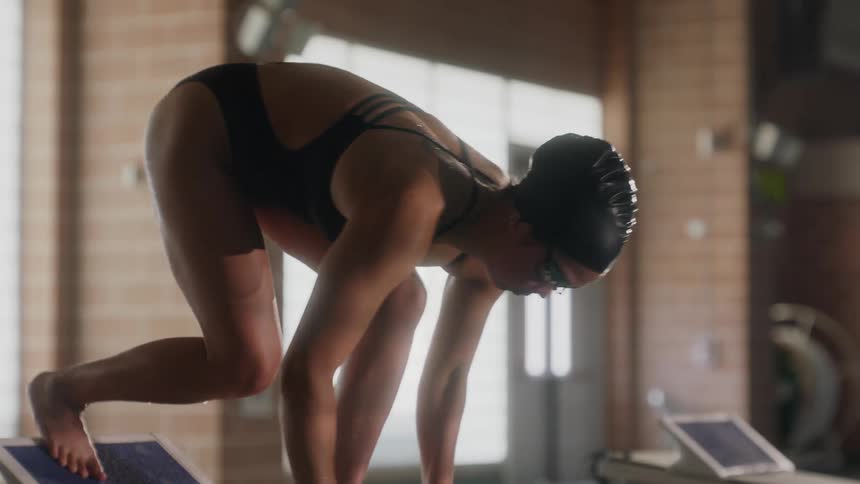 A swimmer diving into a pool showcasing a dynamic and athletic pose