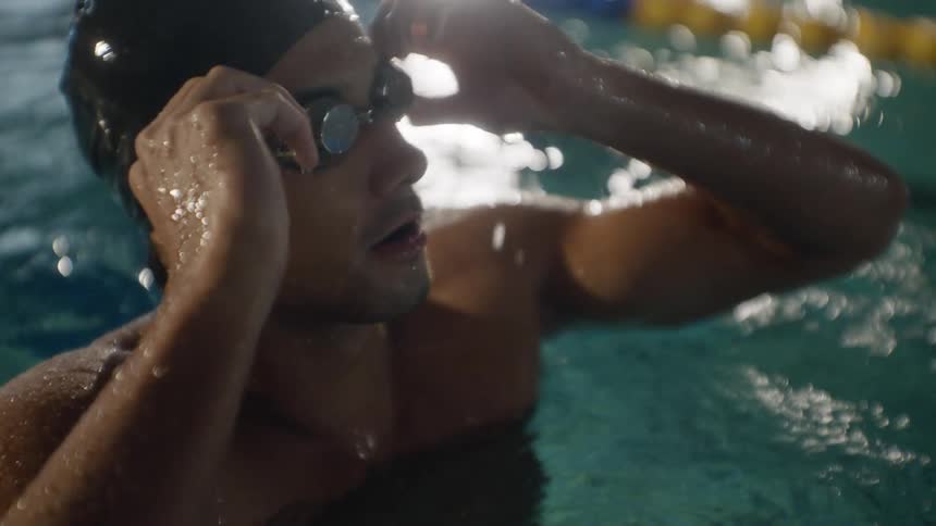 Man swimming in a pool between lane dividers