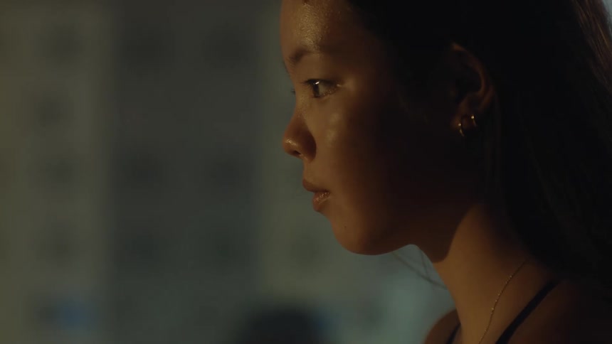 Portrait of a young woman sitting with water reflection on her face