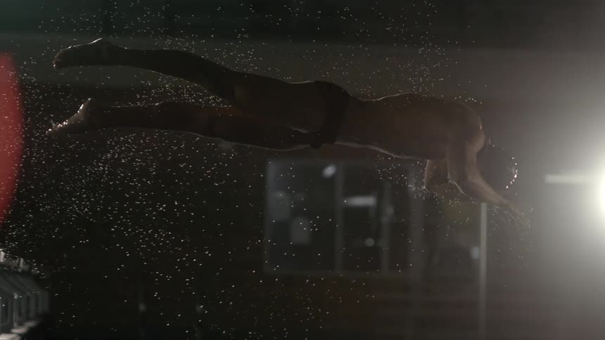 A man dives into the pool