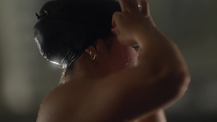 Side portrait of a young woman adjusting her swimming goggles