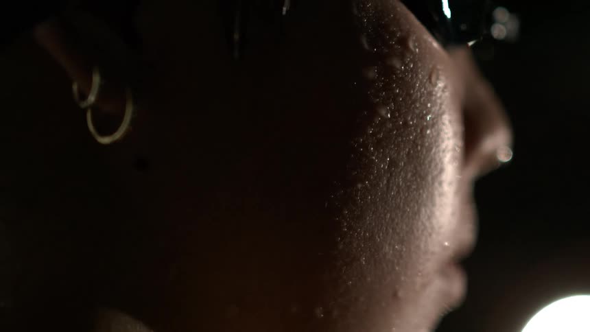 A woman wearing swimming goggles is wet