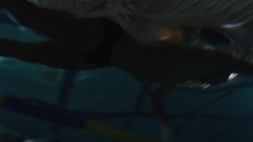 Swimmers race in the pool