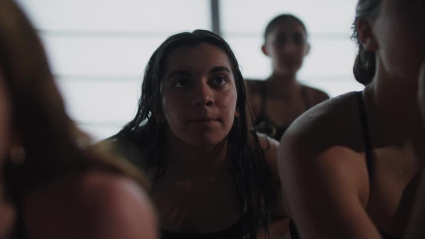 Female swimmers sitting apprehensively