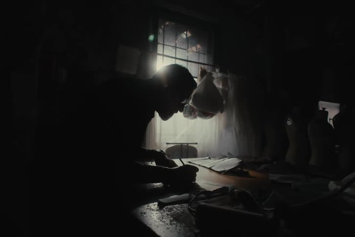 Silhouette of a man working at a desk