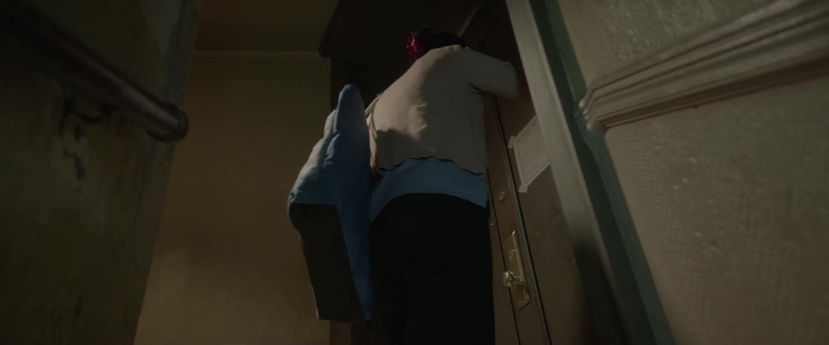 A woman bangs her head against a door