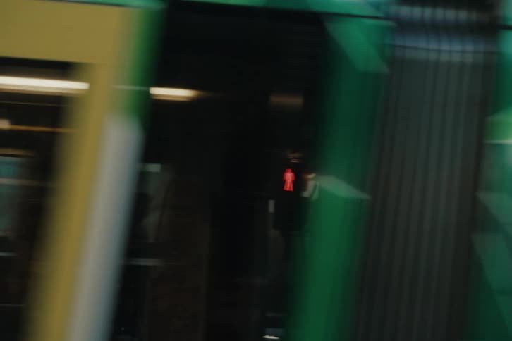 Traffic passes by the pedestrians