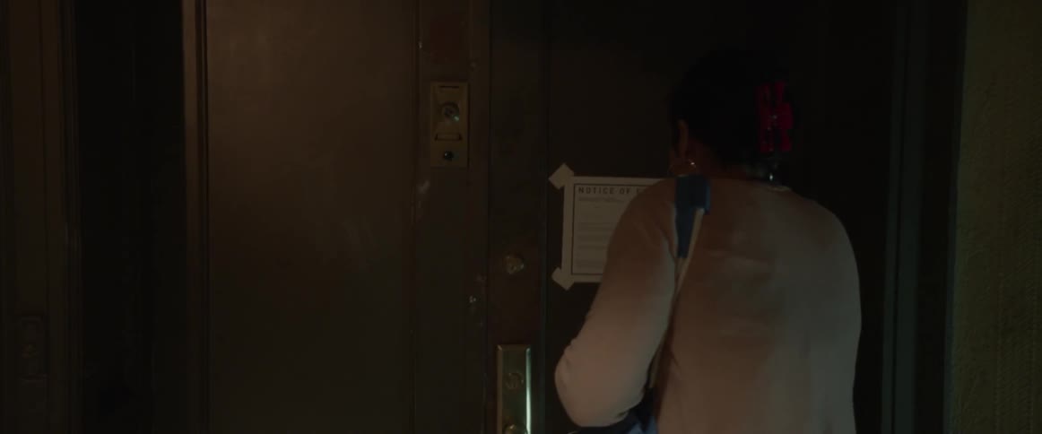 A woman looks for her keys to open her door