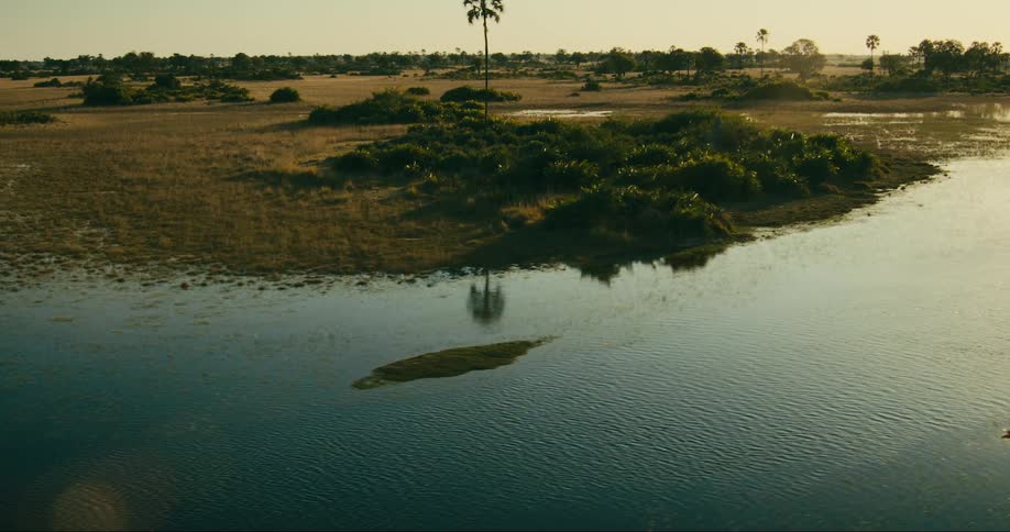 A river surrounding a grass plain
