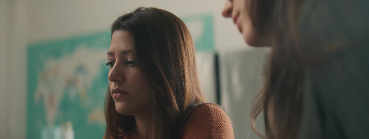 Two women talking about something in front of them