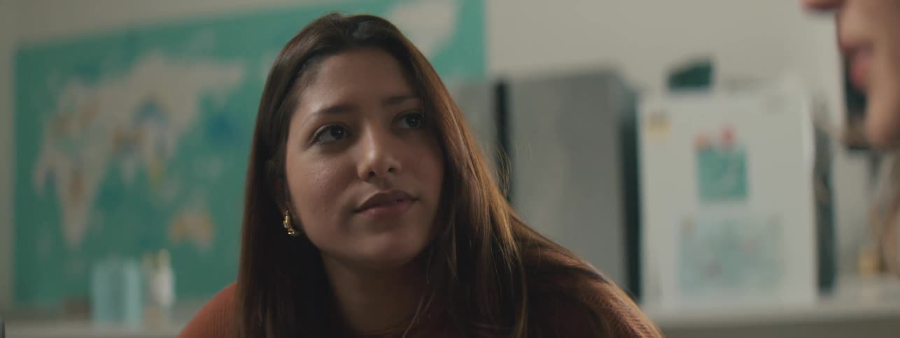 Portrait of a young woman sitting and talking to a colleague next to her