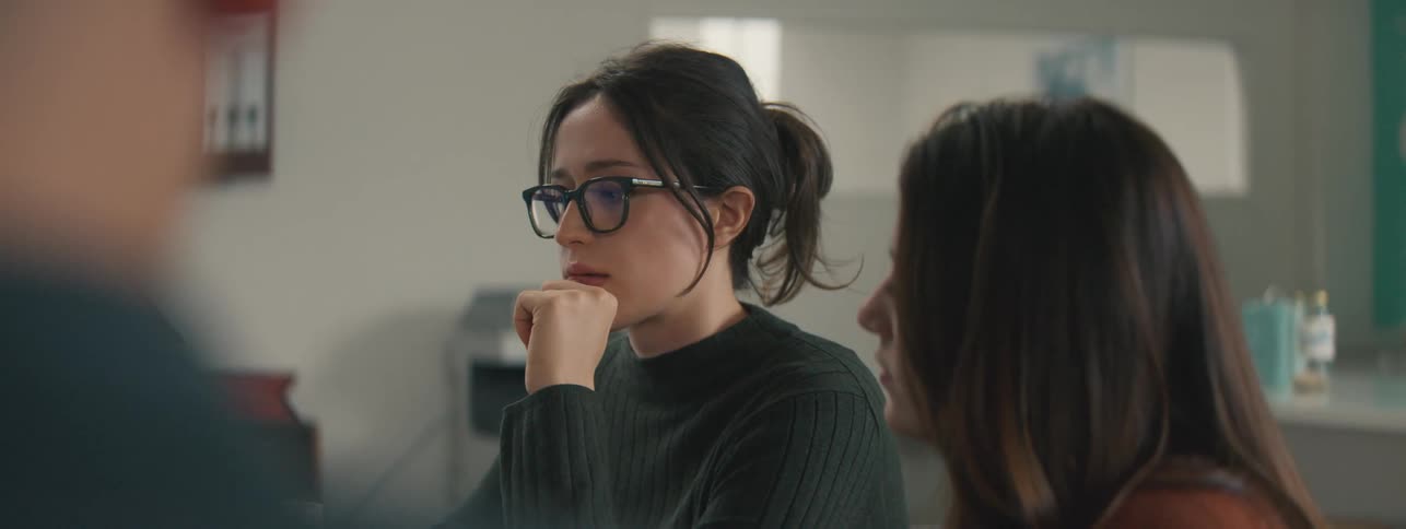 Two women sitting talking and focused
