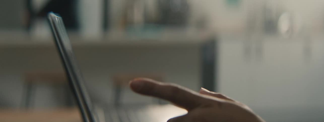 Robotic and human hand interacts with a laptop