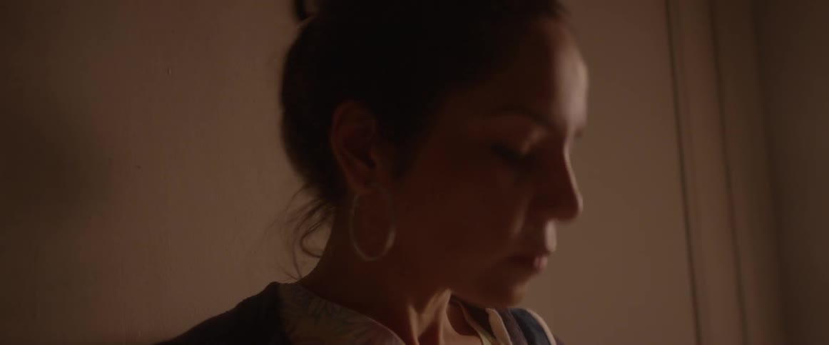 A woman swallows and looks around