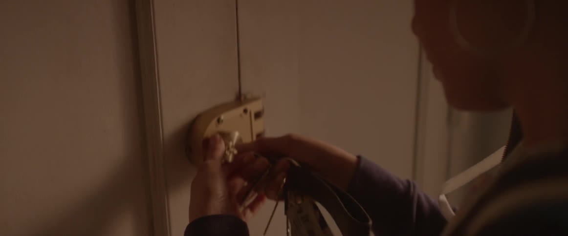 A woman locks her door