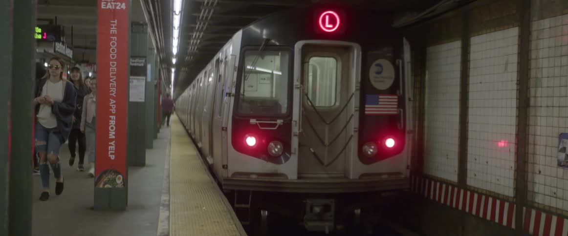 A subway train drives through a station