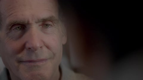 An elderly man smiles