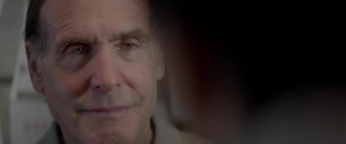 An elderly man smiles