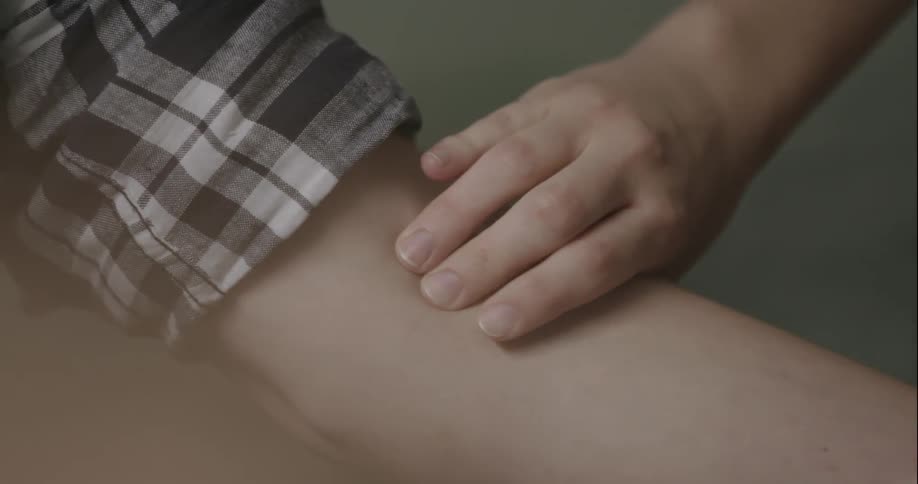 Close up of a hand on an arm