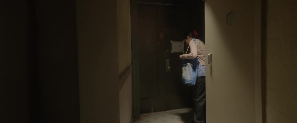 A door opens and a woman exits