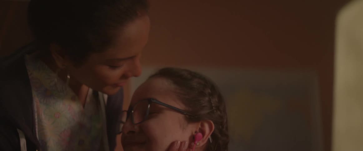 A woman and her daughter are laughing together