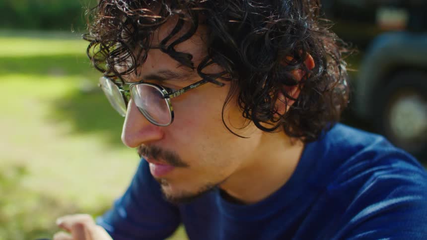 A man in a park looking pensive