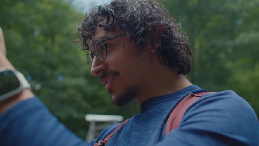 Man using a support tool for an iphone and filming