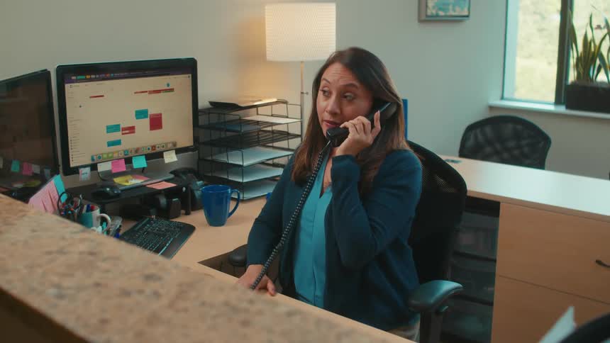 A receptionist talking on the phone