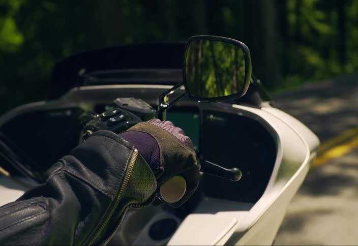 Gloved hand pruning a motorcycle