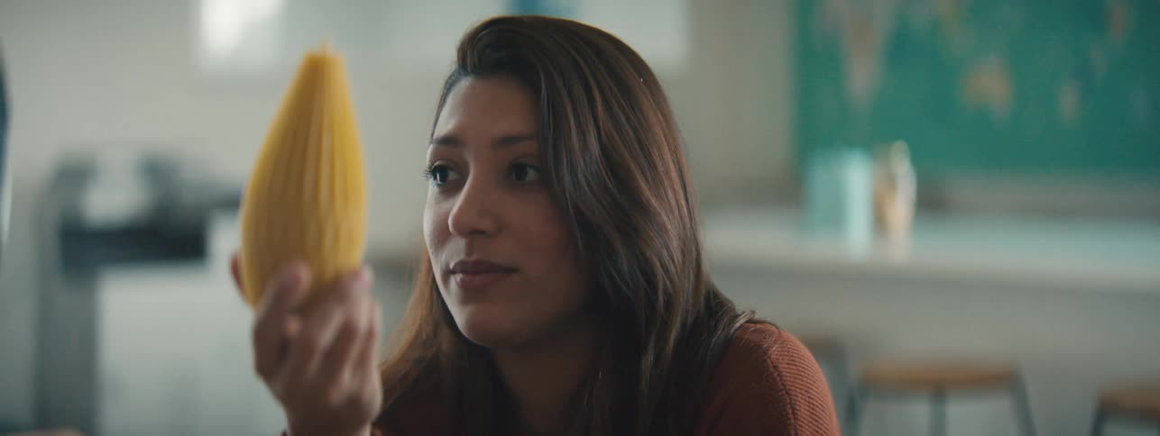 Woman sitting in the office discusses the yellow textured object she is holding