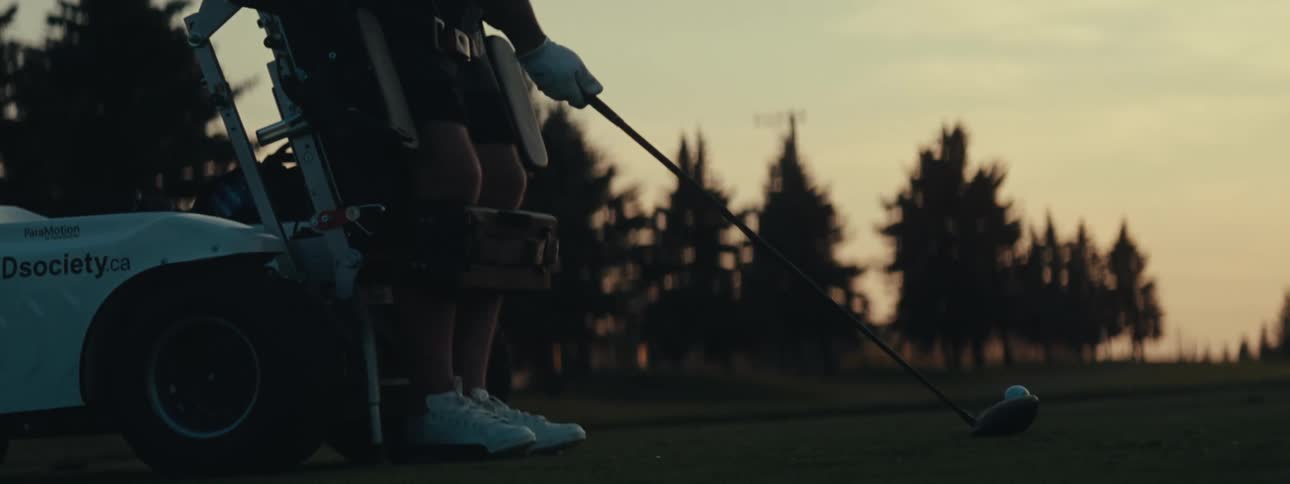 A man is standing in a device while playing golf