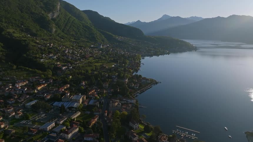 Aerial view of a city on the edge of a lake and surrounded by mountains