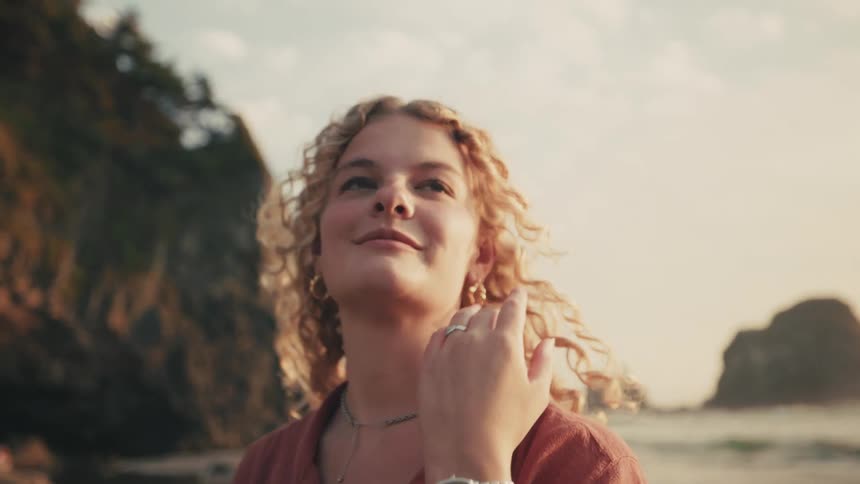 Blonde curly haired woman on the beach