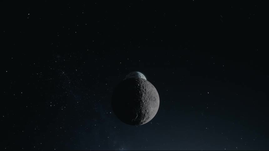 The moon orbiting the earth floating in space lit by the sun