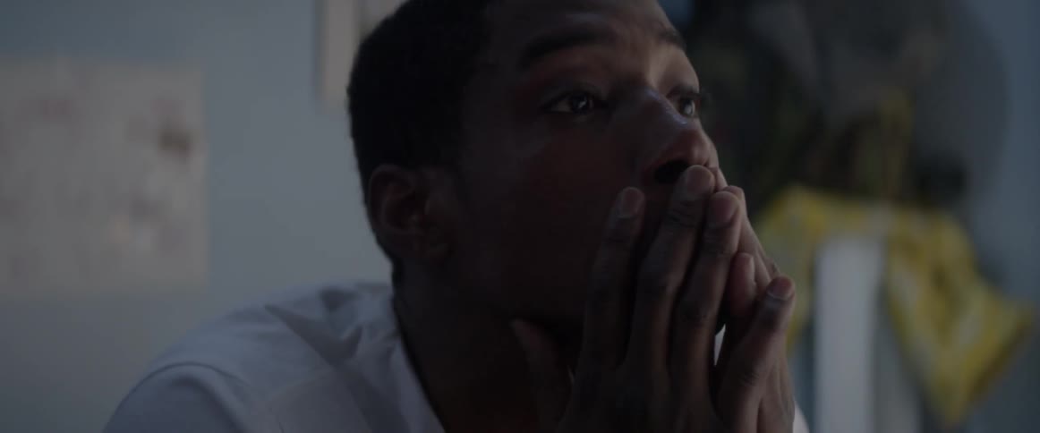 A man rubs his face waking up