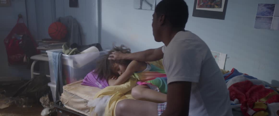 A young man tries to wake up his sister