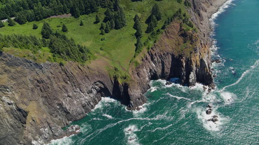 Aerial view of steep coastline with vegetation and seaside