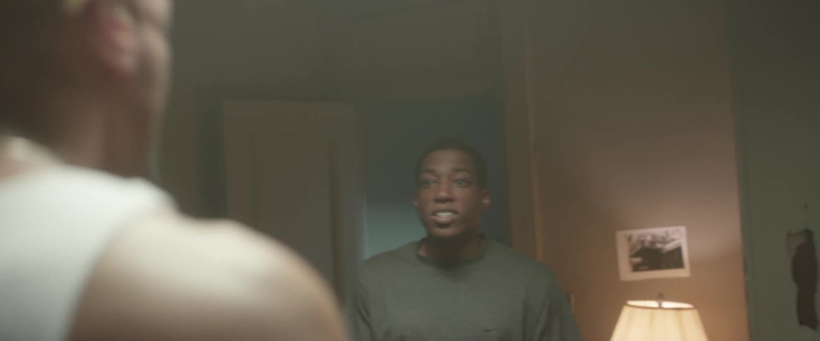 Three people are arguing inside a bedroom