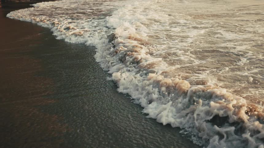 Waves move on the sand