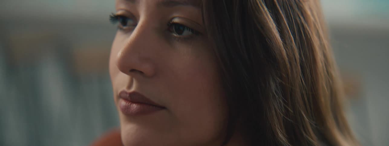 A woman is talking and blinking