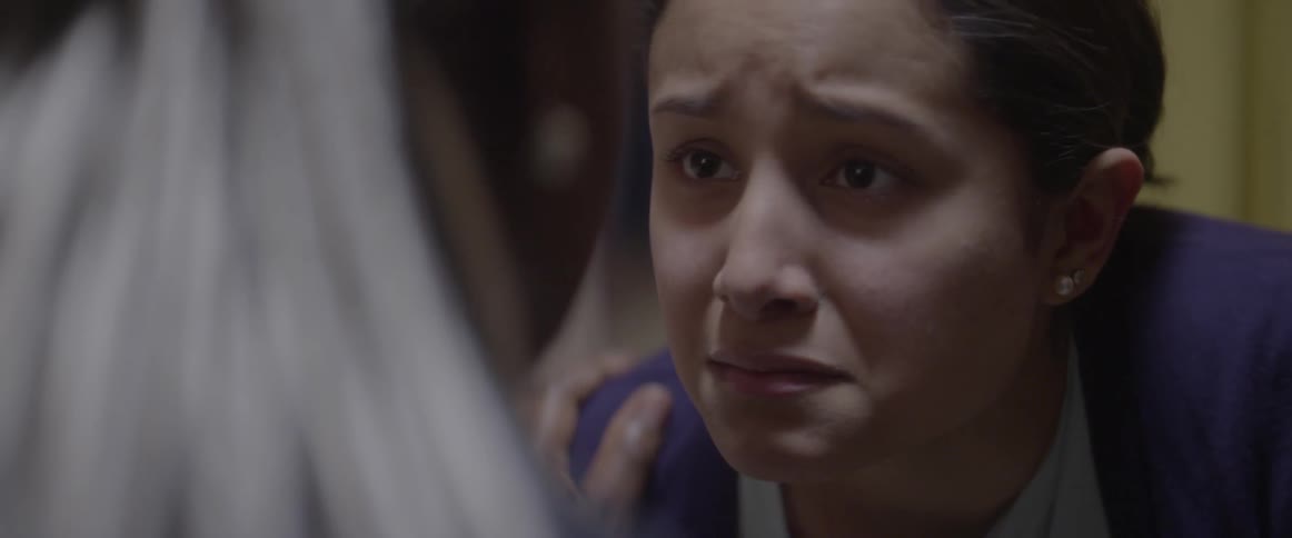 A young sobbing woman is consoled