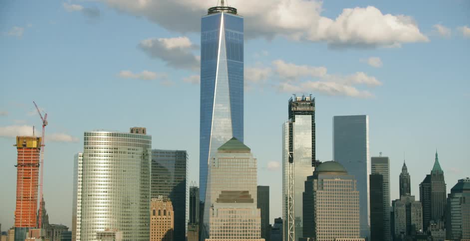 A city skyline is visible on a sunny day